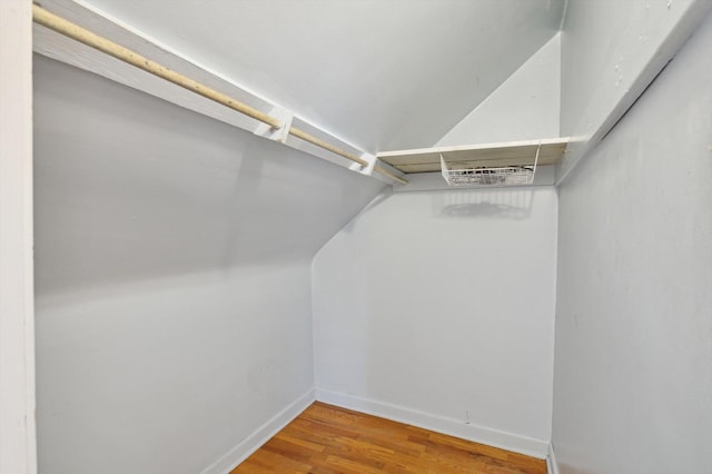 spacious closet with wood finished floors and lofted ceiling