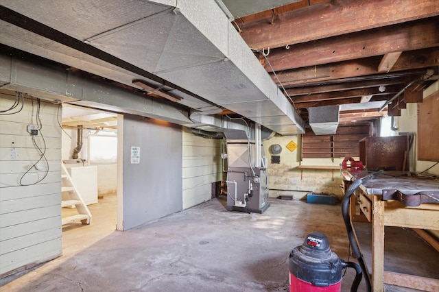 unfinished below grade area featuring washer / clothes dryer and heating unit
