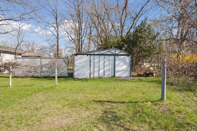 view of yard featuring an outbuilding and a shed