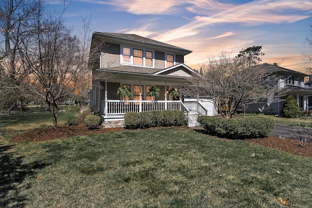 view of front of house with a porch and a yard