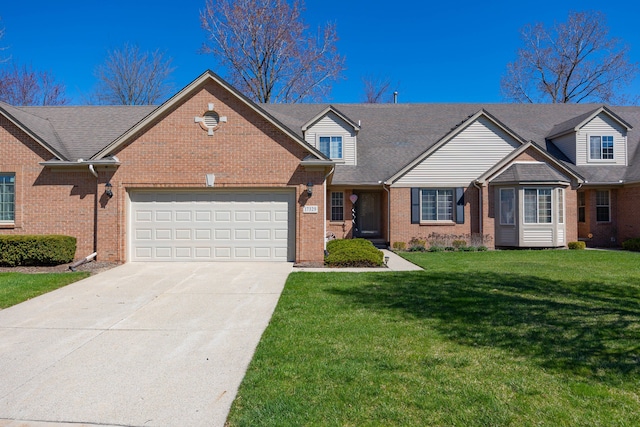 view of front of home with brick siding, a front yard, concrete driveway, and a garage