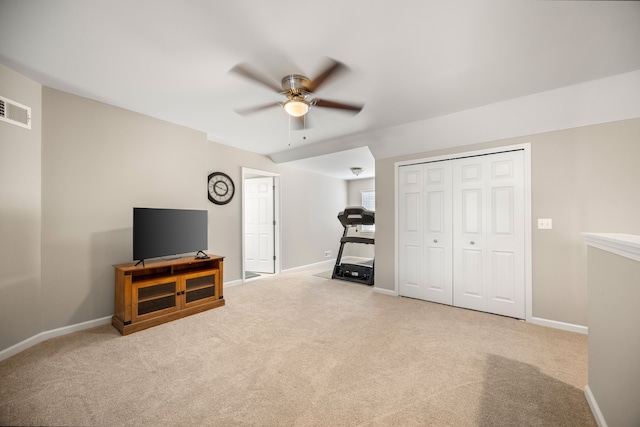 exercise room featuring baseboards, a ceiling fan, visible vents, and carpet
