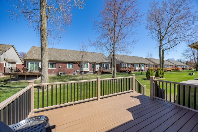 wooden terrace featuring a yard and a residential view
