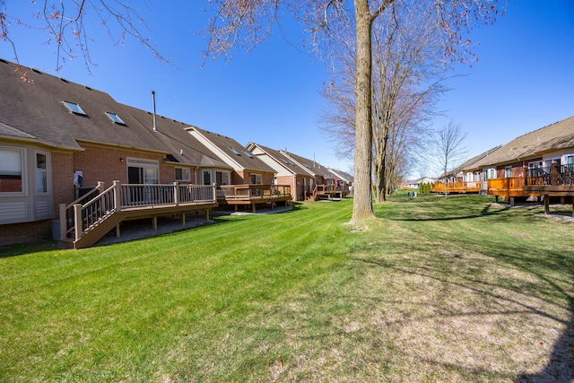 view of yard featuring a residential view and a deck
