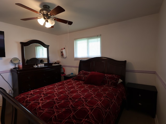 bedroom featuring multiple windows and ceiling fan
