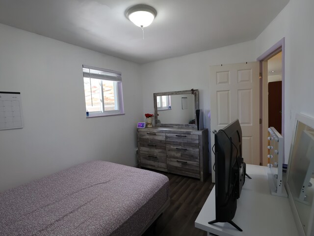 bedroom with dark wood finished floors