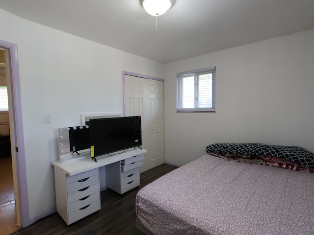 bedroom featuring a closet and dark wood-style flooring