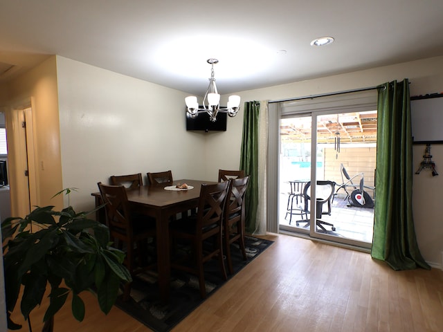 dining room featuring recessed lighting, wood finished floors, and a chandelier