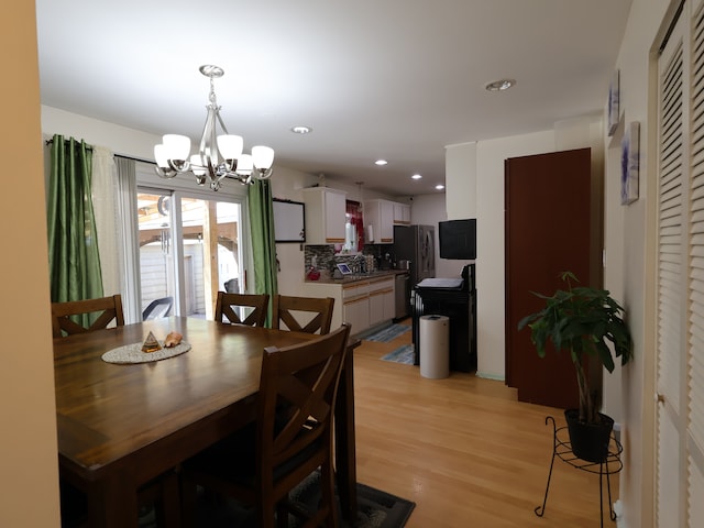 dining area featuring an inviting chandelier, recessed lighting, and light wood-type flooring