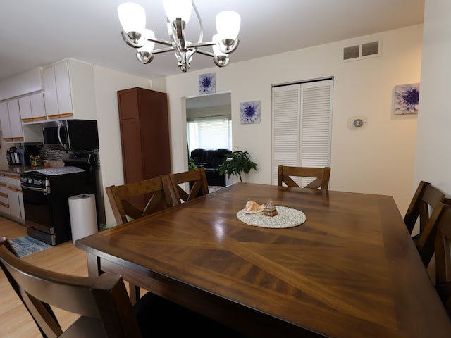 dining space with a chandelier and visible vents