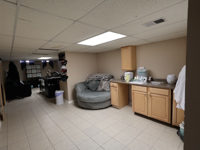 interior space featuring visible vents, a sink, and light tile patterned flooring