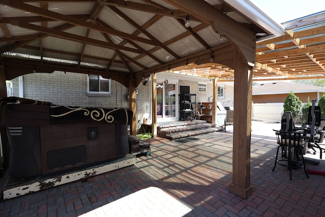 view of patio featuring fence, a pergola, and a gazebo