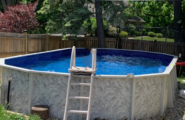 view of swimming pool with a fenced in pool and a fenced backyard