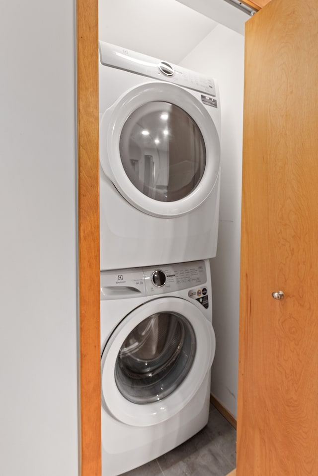 laundry area featuring stacked washing maching and dryer and laundry area