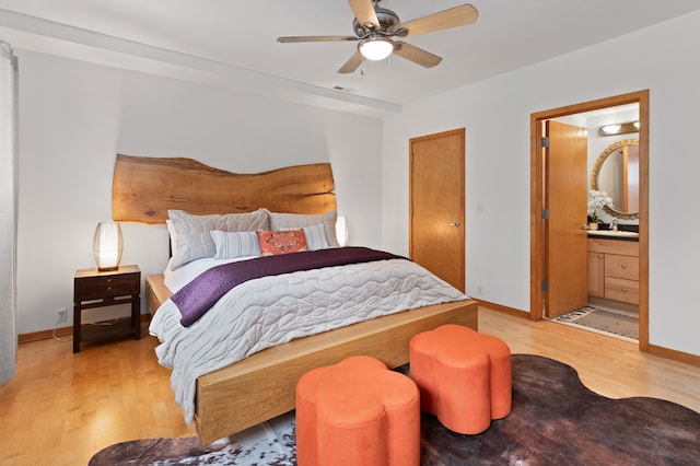 bedroom with visible vents, baseboards, light wood finished floors, and a sink
