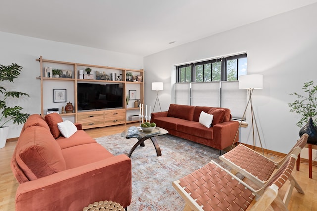 living area featuring baseboards and wood finished floors