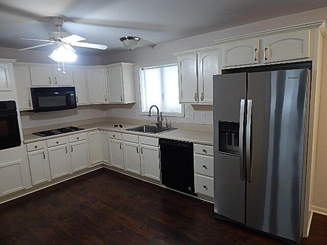 kitchen featuring black appliances, a sink, white cabinetry, ceiling fan, and light countertops