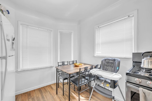 dining area featuring baseboards and wood finished floors