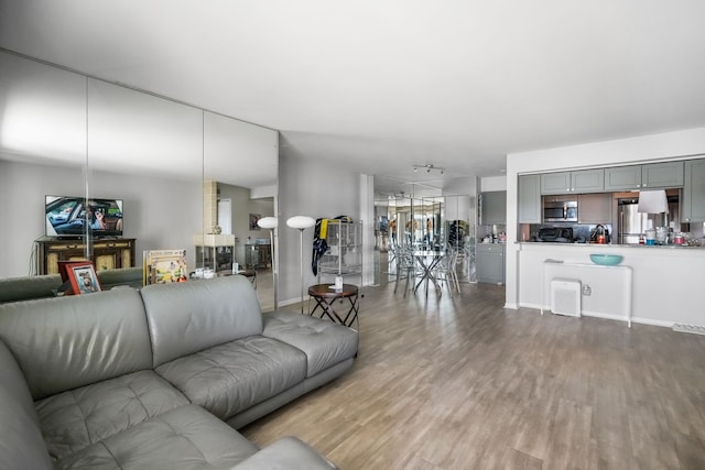 3553 Port Cove Dr Unit 37, Waterford, MI 48328 - living room featuring wood finished floors and baseboards