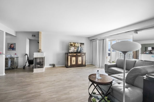3553 Port Cove Dr Unit 37, Waterford, MI 48328 - living area featuring visible vents, light wood-style flooring, and baseboards