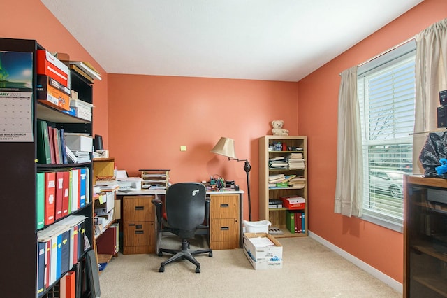 office with a healthy amount of sunlight, baseboards, and light carpet