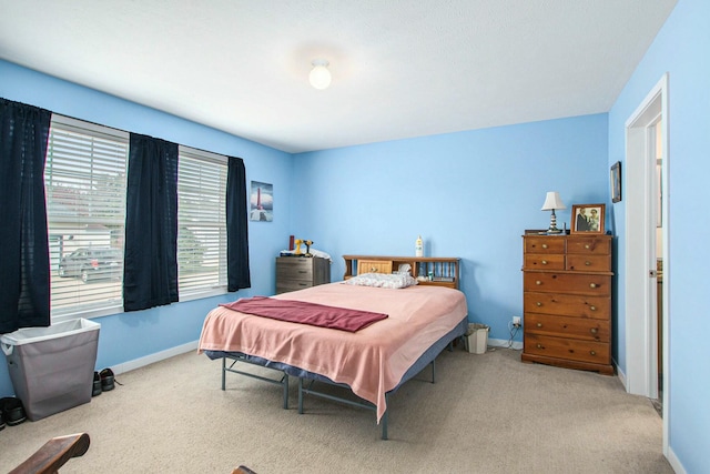 carpeted bedroom featuring baseboards