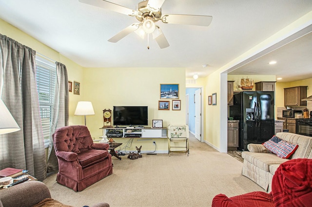 living area featuring recessed lighting, a ceiling fan, baseboards, and light carpet