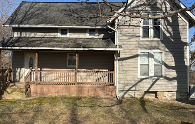 view of front of home featuring a deck and a shingled roof