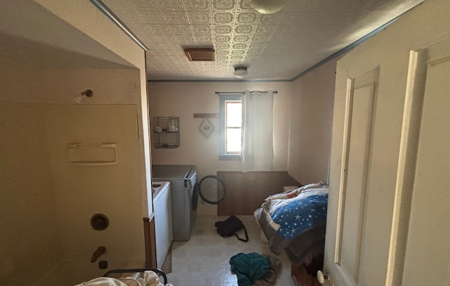 washroom with an ornate ceiling, carpet flooring, washing machine and clothes dryer, and laundry area
