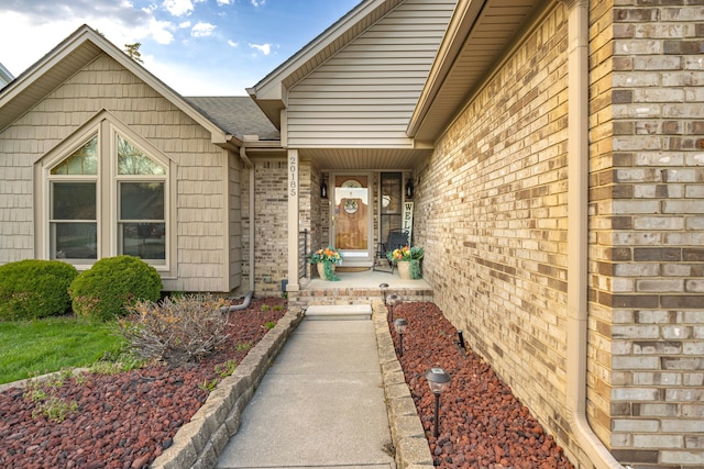 doorway to property with brick siding