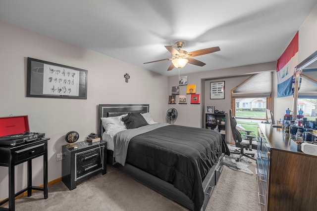 bedroom with light colored carpet and a ceiling fan