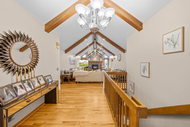 interior space featuring an inviting chandelier, vaulted ceiling with beams, and light wood finished floors