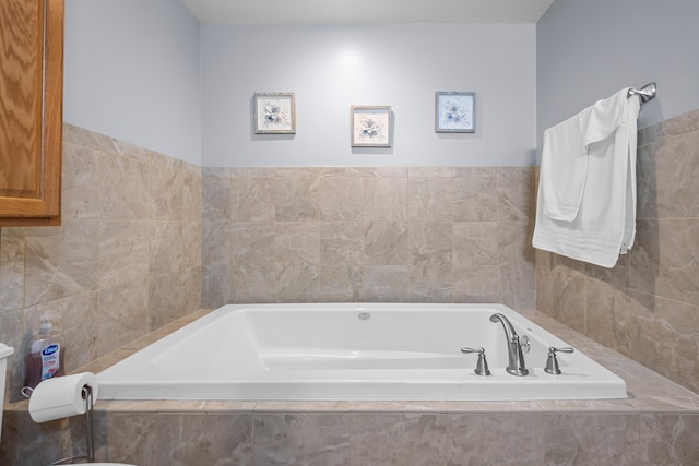 full bath with tile walls and a bath