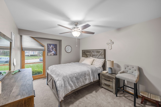bedroom with light colored carpet and ceiling fan