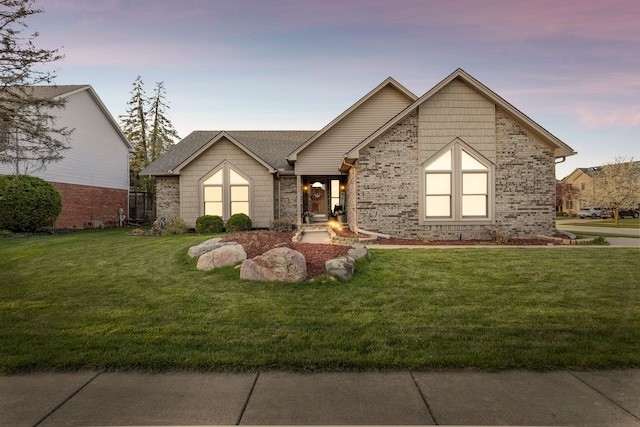 single story home with a lawn and brick siding