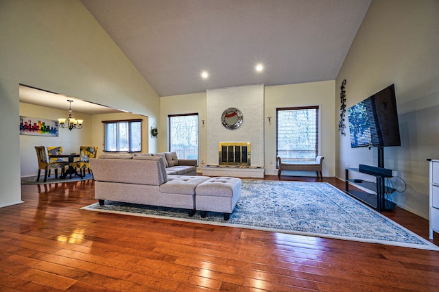 3052 Westman Ct, Bloomfield Hills, MI 48304 - living area featuring hardwood / wood-style flooring, baseboards, high vaulted ceiling, and a notable chandelier