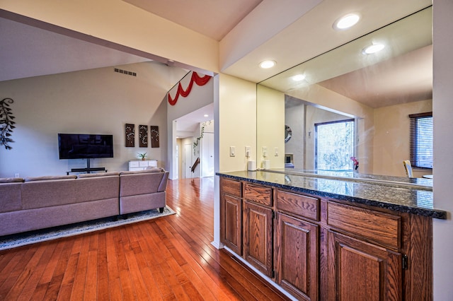 3052 Westman Ct, Bloomfield Hills, MI 48304 - kitchen featuring wood-type flooring, dark stone countertops, visible vents, and recessed lighting