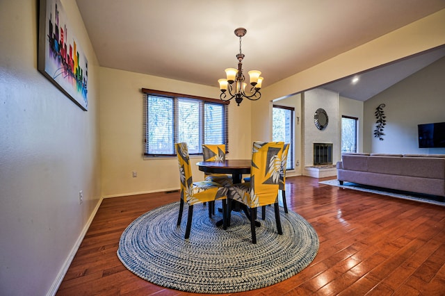 3052 Westman Ct, Bloomfield Hills, MI 48304 - dining space featuring vaulted ceiling, hardwood / wood-style flooring, an inviting chandelier, a fireplace, and baseboards