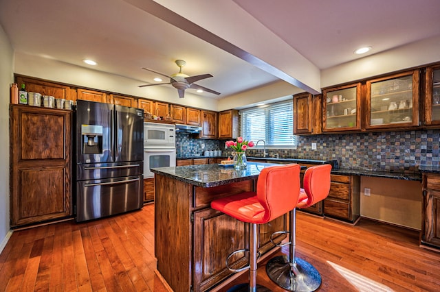 3052 Westman Ct, Bloomfield Hills, MI 48304 - kitchen with dark wood-style floors, backsplash, and white appliances