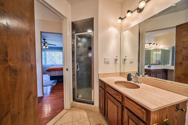 3052 Westman Ct, Bloomfield Hills, MI 48304 - ensuite bathroom with a stall shower, connected bathroom, vanity, ceiling fan, and tile patterned flooring