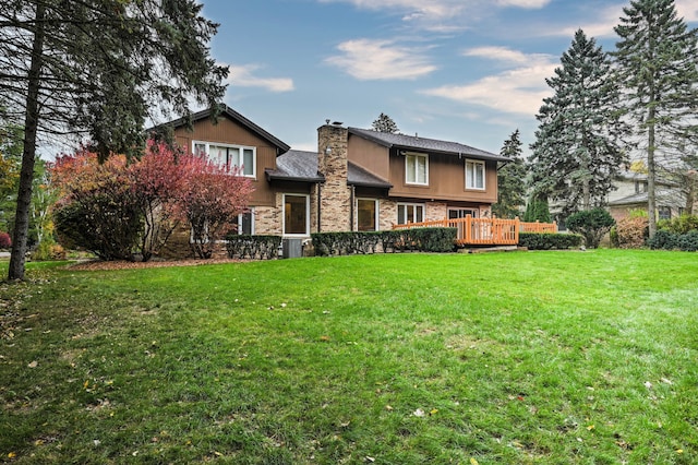 3052 Westman Ct, Bloomfield Hills, MI 48304 - rear view of house with a chimney, a wooden deck, and a yard