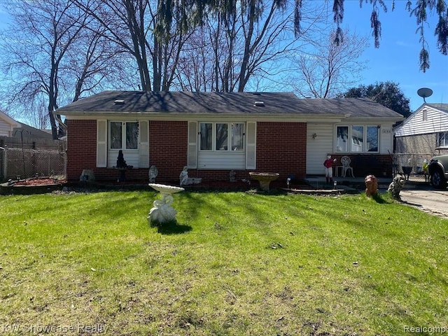41541 Mcbride Ave, Van Buren, MI 48111 - ranch-style house with brick siding, a front yard, and fence