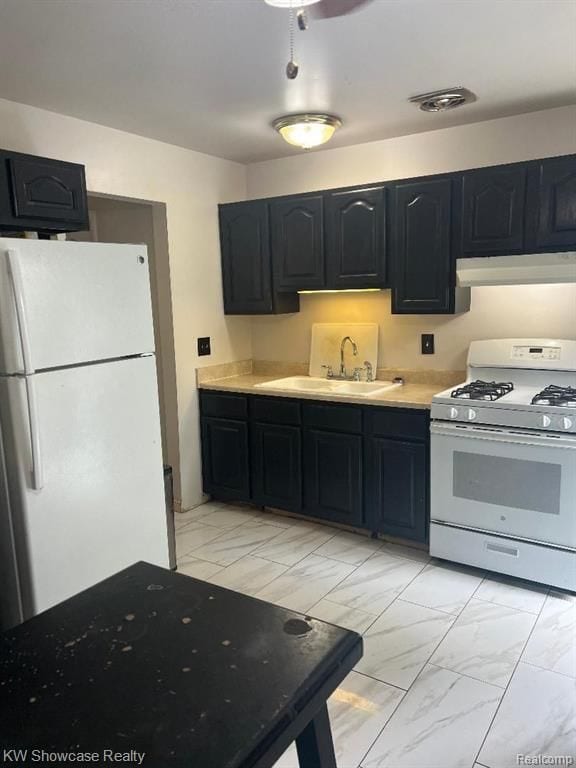 41541 Mcbride Ave, Van Buren, MI 48111 - kitchen featuring marble finish floor, under cabinet range hood, light countertops, a sink, and white appliances