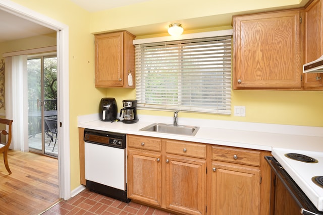 kitchen with white dishwasher, a sink, light countertops, and range with electric cooktop