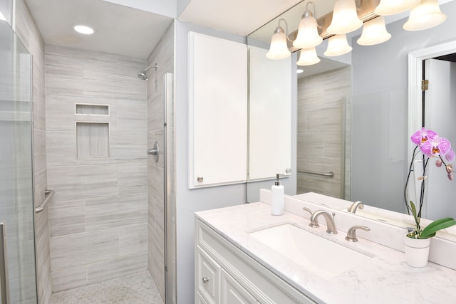 full bath with a shower stall, vanity, and recessed lighting