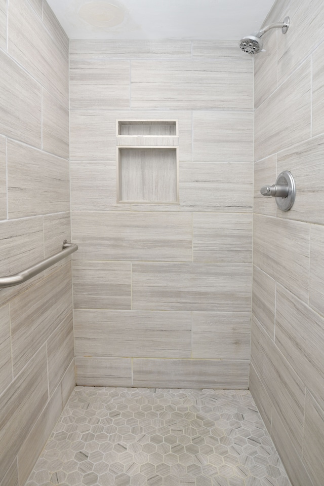 bathroom with a tile shower