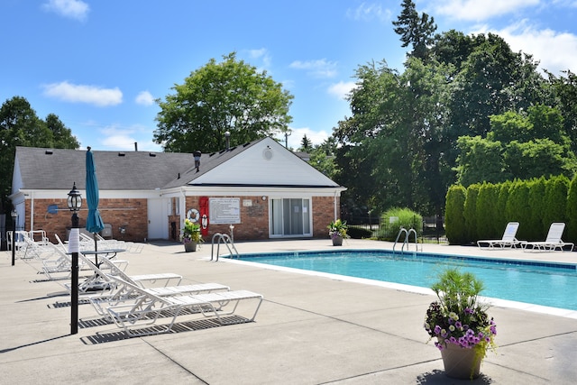 community pool featuring a patio area and fence