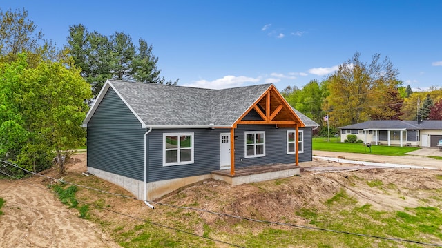 10820 Baker Rd, Jerome, MI 49249 - view of front facade featuring roof with shingles and a porch