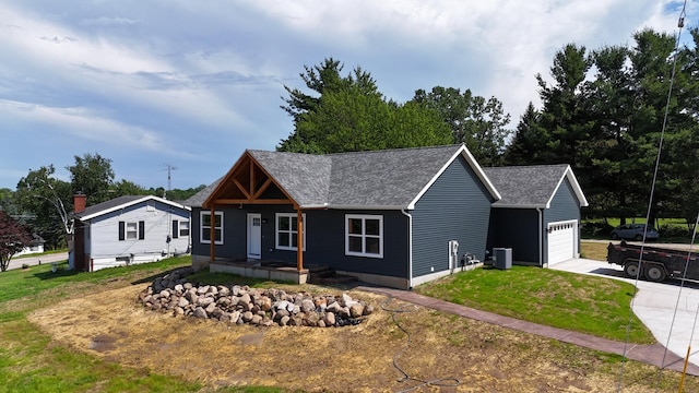 10820 Baker Rd, Jerome, MI 49249 - view of front of house with a garage, a porch, a front lawn, concrete driveway, and roof with shingles