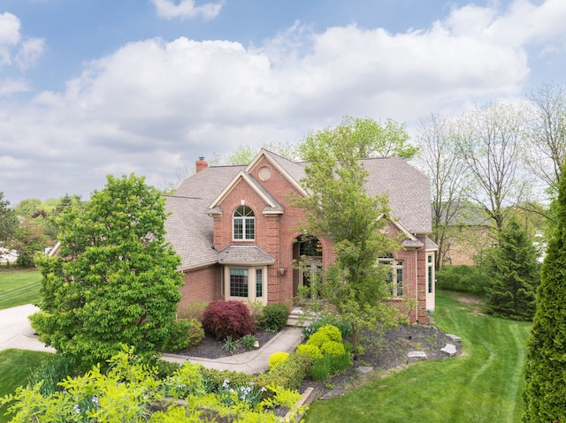 24160 Argyle St, Novi, MI 48374 - traditional-style home featuring brick siding, a front lawn, a chimney, and roof with shingles